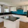 White Gloss Handless Kitchen & Island with Black Granite & Appliances