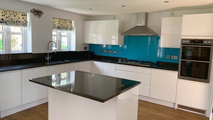 White Gloss Handless Kitchen & Island with Black Granite & Appliances