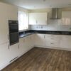 Symphony Modern Off White Gloss Kitchen AEG Appliances & More Black Granite Worktops