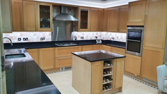 Tan Wood kitchen with Black Granite & Appliances