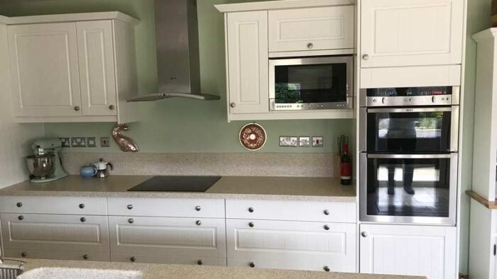 White Shaker Kitchen & Island with Corian Worktops & Neff Appliances