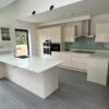 Howdens Modern Handleless Kitchen & Peninsular AEG Neff Appliances Stone Worktops