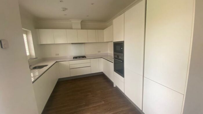 Hacker Modern Matt White Handless Channel Rail Kitchen AEG Appliances Silestone Worktops