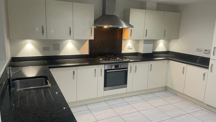 Symphony Buttercream Gloss Kitchen AEG Appliances Granite Worktops