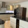 Howdens Ivory Gloss Handless Kitchen & Island - Bosch Appliances - Black Granite Worktops - LED lighting