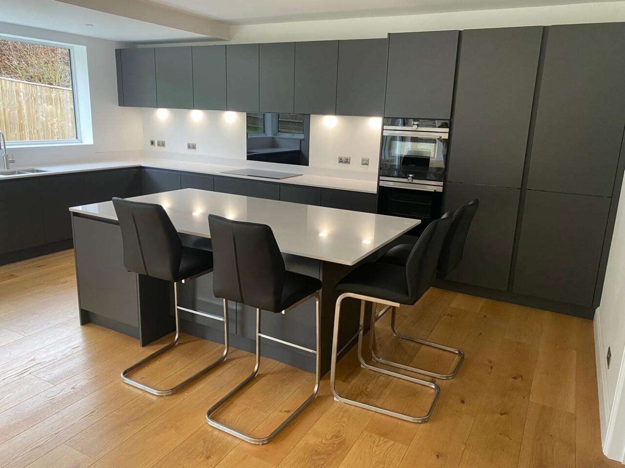 Burnhill Graphite Grey Matt Handless Kitchen, Island and J Handled Utility Room Siemens Neff Elica Appliances White Quartz Worktops