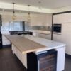 Large Modern Light Buttercream Gloss Kitchen & Island Neff Quooker Appliances White Corian Worktops