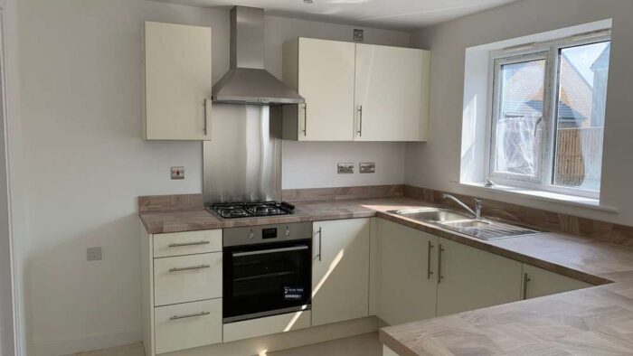 Roundell Alabaster Slab Door Kitchen & matching Utility Room Electrolux Appliances Light Oak Laminate Worktops