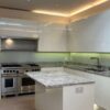 Mowlem & Co White Gloss + Stone Textured Handleless Kitchen & Island