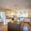 Luxury Modern Handleless White Nicholas Anthony Kitchen & Island & Matching Utility Room – Gaggenau Siemens Appliances – Granite Worktops with Waterfall Sides