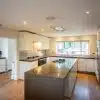 Luxury Modern Handleless White Nicholas Anthony Kitchen & Island & Matching Utility Room – Gaggenau Siemens Appliances – Granite Worktops with Waterfall Sides