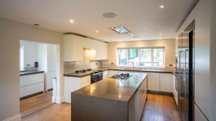 Luxury Modern Handleless White Nicholas Anthony Kitchen & Island & Matching Utility Room – Gaggenau Siemens Appliances – Granite Worktops with Waterfall Sides