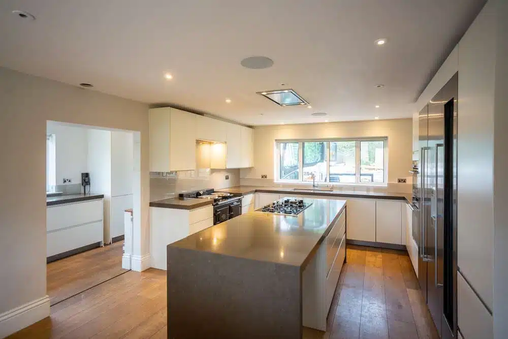 Luxury Modern Handleless White Nicholas Anthony Kitchen & Island & Matching Utility Room – Gaggenau Siemens Appliances – Granite Worktops with Waterfall Sides