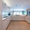 Luxury Roundhouse Gloss White Kitchen and Peninsula - Gaggenau Miele Appliances – White Corian Worktops