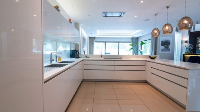 Luxury Roundhouse Gloss White Kitchen and Peninsula - Gaggenau Miele Appliances – White Corian Worktops