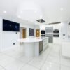 Luxury Tom Howley White Gloss Kitchen with Island & Utility Room - Miele Neff Appliances - White Quartz Worktops