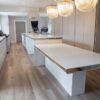 Bespoke Luxury Harrison Collier Stone Grey Kitchen and Large Island with Dining Table – Miele Appliances – White Corian Worktops