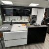 Ex-Display-Hacker-Systemat-Dark-Pine-Effect-Kitchen-with-Island-–-Quooker-Neff-De-Dietrich-Appliances-Putty-Concrete-Pearl-Grey-Worktops