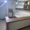 Ex Display Scavolini Evolution Handleless with Breakfast Bar – Neff Appliances – 40mm Laminate White Worktops inc Breakfast Bar