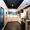 Ex Display Schmidt Arcos in Vison and Slow Wood and Loft Micron in Moody Blue Kitchen with Peninsular – Bosch Appliances - Slow Wood Laminate Worktop