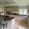 Large Modern Taupe Gloss Soft Close Handleless Kitchen with Island and Utility Room – Zug Smeg Zanussi Appliances – Grey Silestone Worktops