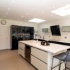 Large Italian Cucine Colone Modern Black & Buttercream Gloss Kitchen & Matching Island – Siemens Neff Quooker Appliances – Corian Worktops with Waterfall Sides