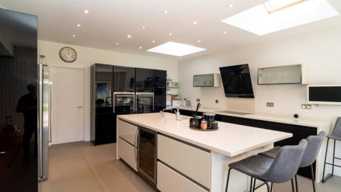 Large Italian Cucine Colone Modern Black & Buttercream Gloss Kitchen & Matching Island – Siemens Neff Quooker Appliances – Corian Worktops with Waterfall Sides