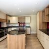 Leicht Large Buttercream and Wood Effect Kitchen with Island and Utility Room – Neff Liebherr Appliances – Black Granite Worktops