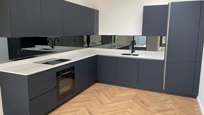 New Installed Unused Pronorm Navy Blue Handleless Kitchen – Bosch Appliances – White Corian Worktops