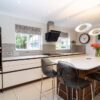 Rotpunkt Handleless Buttercream and Walnut Kitchen with Matching Island and Utility Room – Kuppersbusch Liebherr Caple Appliances - Caesarstone Worktops