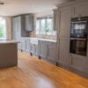 Wren Dusk Grey Shaker Kitchen including Matching Island with Breakfast Bar– AEG Bosch CDA Appliances – White Quartz Worktop