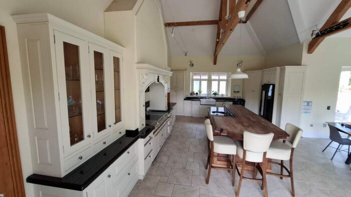 Bespoke Wood Door Buttercream Dovetail Joint Kitchen and Large Island with Breakfast Bar- Bosch Appliances – Black Granite Worktops