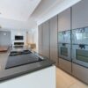 Modern Handleless Taupe Kitchen with Large Island inc Breakfast Bar & Utility Room - Gaggenau Quooker Appliances – Quartz Worktops