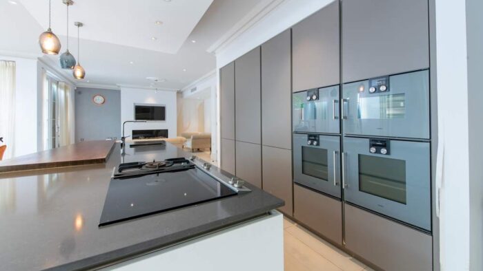 Modern Handleless Taupe Kitchen with Large Island inc Breakfast Bar & Utility Room - Gaggenau Quooker Appliances – Quartz Worktops