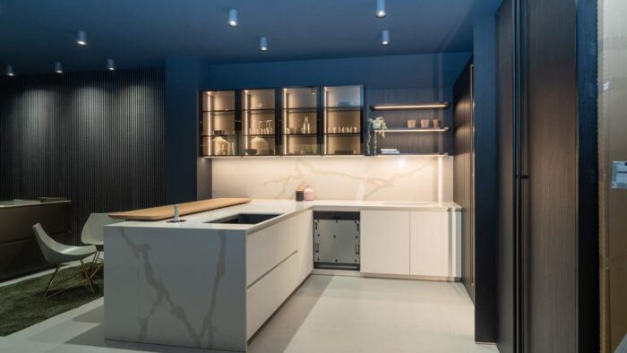 Ex Display Italian Luxury Ernestomeda One Fenix Bianco Kos Glass In Fume Rovere Blackwood Pocket Door Kitchen including Peninsular with Wooden Breakfast Bar – Bora Siemens Appliances - Stone Italiana Marmorea Golden Worktops