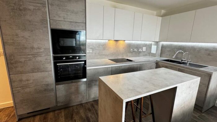 Modern Young Taupe & Ivory Handleless Kitchen with Island – Electrolux Appliances - Laminate Worktops