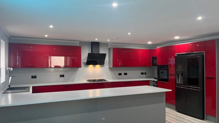 Young Modern Red Gloss with Black Handled Kitchen with Peninsula – Neff CDA LG Appliances – White Krion Worktops