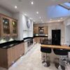 Howdens Wood Like and Buttercream Shaker Kitchen with Island and Breakfast Bar – Bosch Indesit Lamona Appliances – Granite Worktops