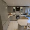 Howdens Clerkenwell Dove Grey J Handled Kitchen with Peninsula – AEG Bosch Zanussi Appliances – Laminate Worktops