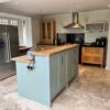 Anthony Mullen Sage Green & Wood Like Separate Kitchen and Island – Neff Appliance – Granite and Wooden Worktops