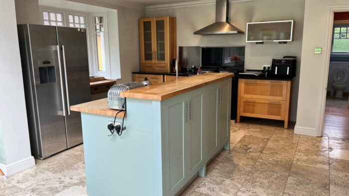 Anthony Mullen Sage Green & Wood Like Separate Kitchen and Island – Neff Appliance – Granite and Wooden Worktops