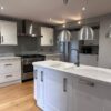 Howdens White Shaker Kitchen including Island with Glass Breakfast Bar – Rangemaster Lamona Hotpoint Appliances – Corian Worktops