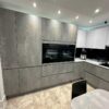 Ex Display Hacker Comet GL & Laser Brilliant GL Putty Concrete Pearl Grey & Polar White Kitchen with Peninsula – Siemens Appliance – Carrara White Laminate Worktop