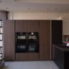 Ex Display Nobilia Walnut Look and Black Matt Handleless Kitchen – Bosch Neff Blanco Appliances - Dekton Luarent 20mm Worktops