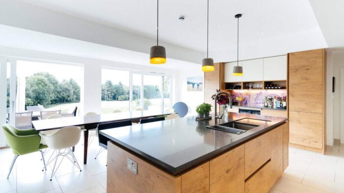 Rotpunkt & Bespoke Wood Look and White Chrome Handled Kitchen and Matching Rotpunkt Island – Miele Neff Liebherr Appliances – Caesarstone Worktops