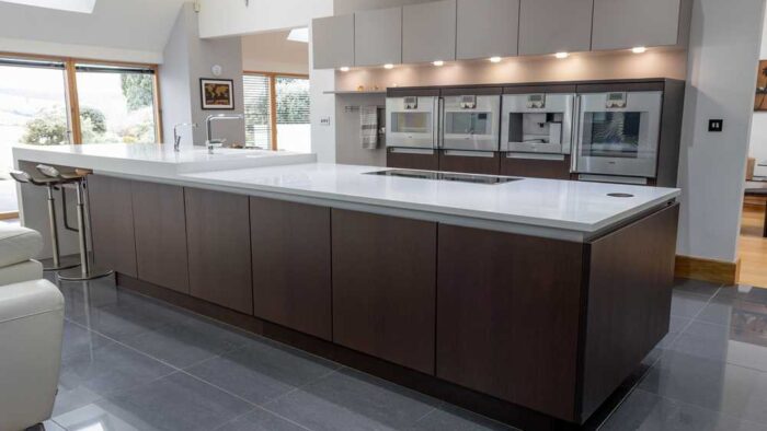 Luxury Poggenpohl Dark Wood Kitchen and Large Matching Island with Breakfast Bar– Gaggenau Quooker Miele Appliances – White Corian Worktops