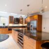 Luxury Smallbone Walnut & Silver Stained Slatted Kitchen with Matching Island - Traditional Satin Chrome Butt Hinges – Siemens Elica Appliances – Black Granite Worktops