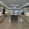 Large Buttercream Modern Slab Kitchen with Grey Large Island - Bosch Liebherr Appliances - Quartz Worktops