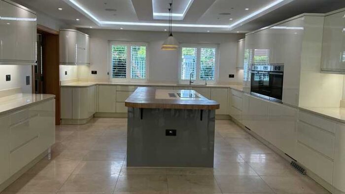 Large Buttercream Modern Slab Kitchen with Grey Large Island - Bosch Liebherr Appliances - Quartz Worktops