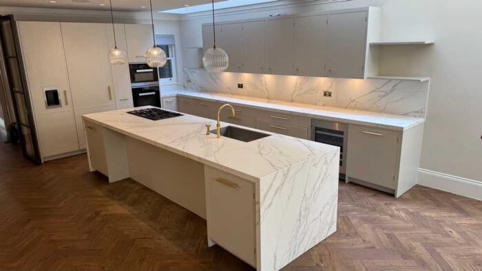 Luxury 202 Design Bespoke In Frame Stone Grey Dovetail Joint with Brass Fittings Kitchen and Large Matching Island – Gaggenau Appliance - Calacatta C01 Silk Neolith Porcelain Worktops